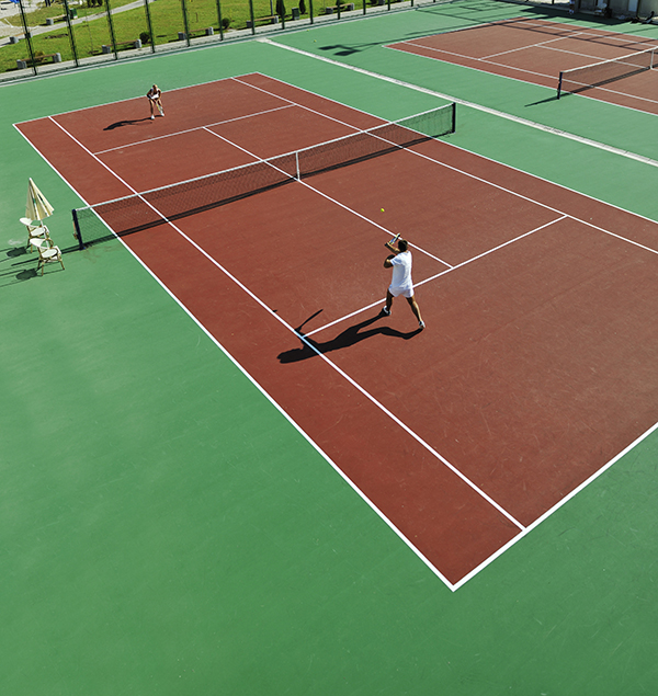 happy young couple play tennis game outdoor man and woman